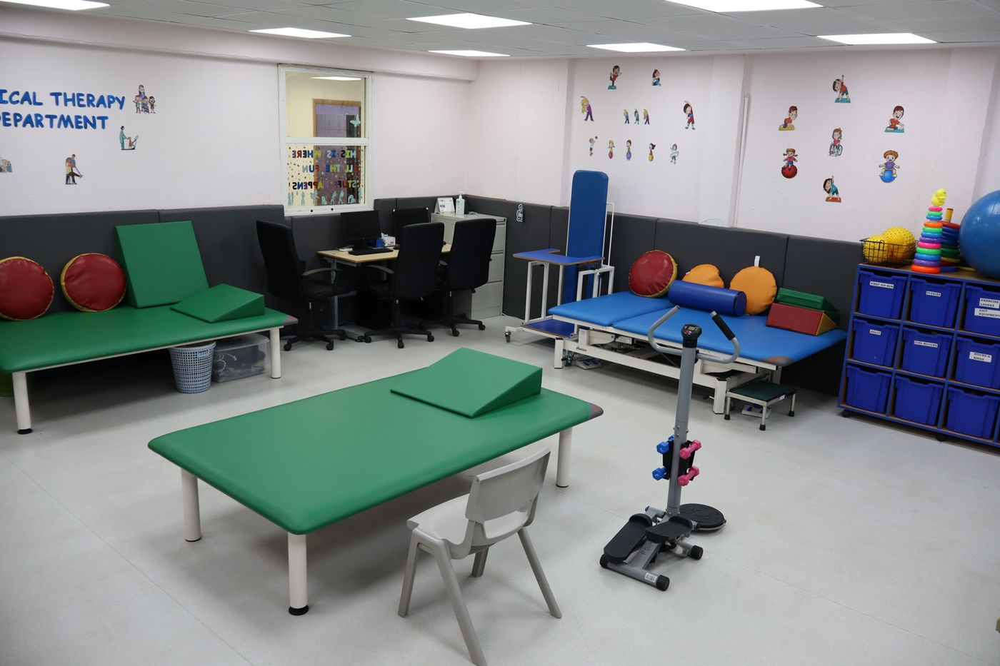 The CESK physical therapy room with treatment tables, exercise balls and wall equipment