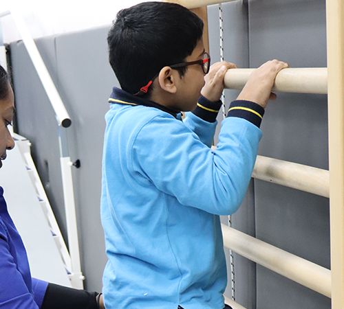 A CESK student exercising on wall bars